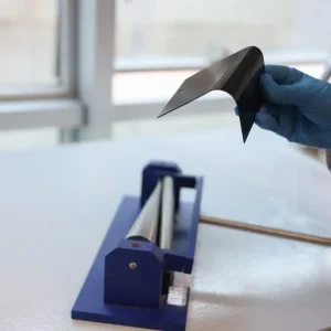 Kaplanmış metal numune üzerinde gerçekleştirilen bükme testinde kaplamanın esneme ve deformasyon dayanımının değerlendirildiği laboratuvar uygulaması.